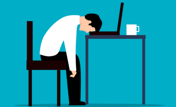 exhausted-man-slumped-over-desk